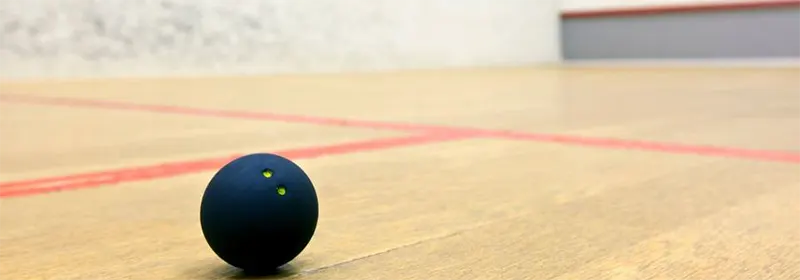 A squash ball on a squash court