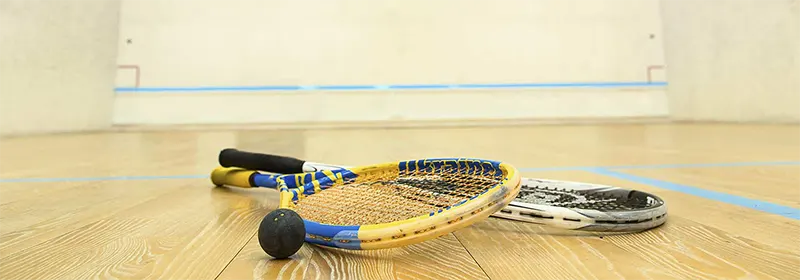 Two squash rackets and a ball