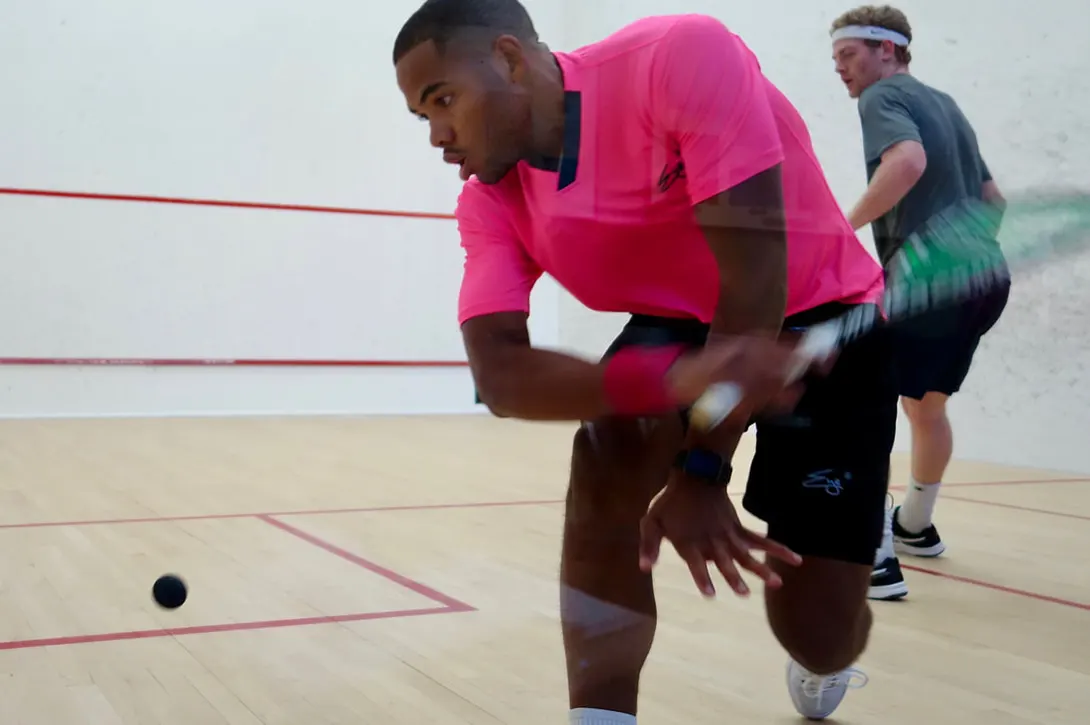 two advanced squash plays in the middle of a rally