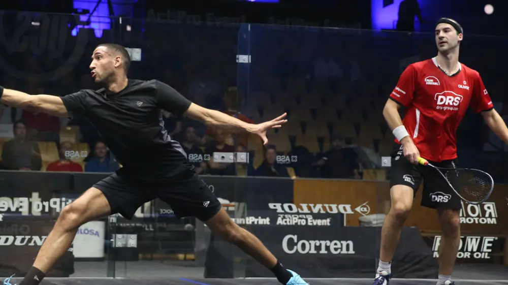 Two Professional squash players in the heat of battle