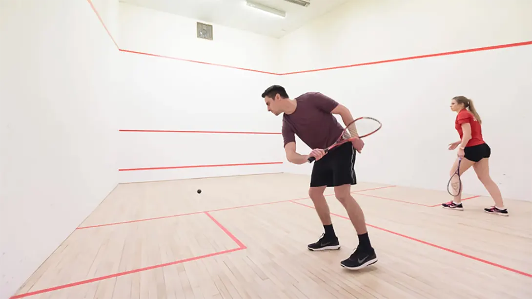 Two people playing squash