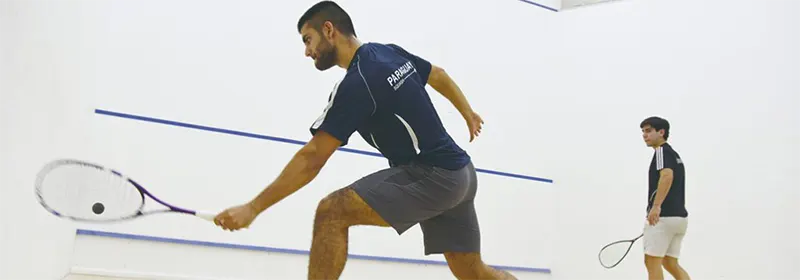 Two people playing squash