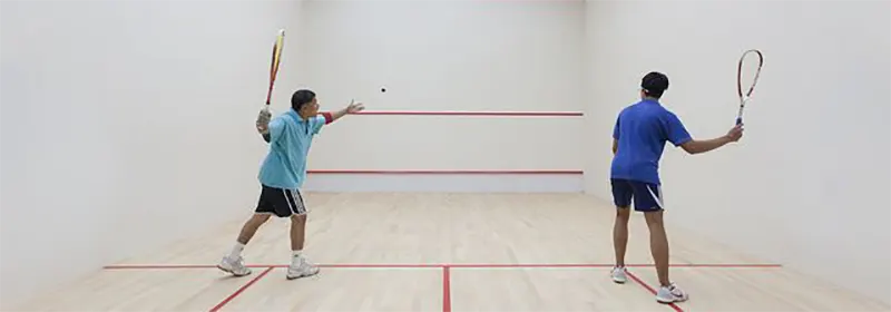 Two men having fun playing squash