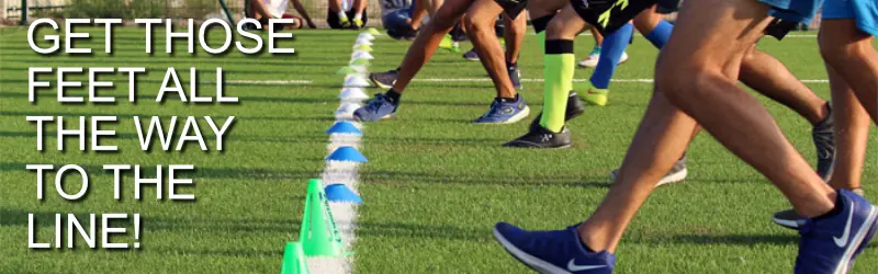 A low view of a group of athletes doing shuttle runs