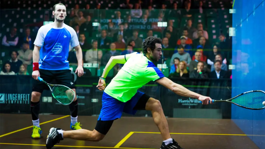 Two professional squash players on an all-glass court