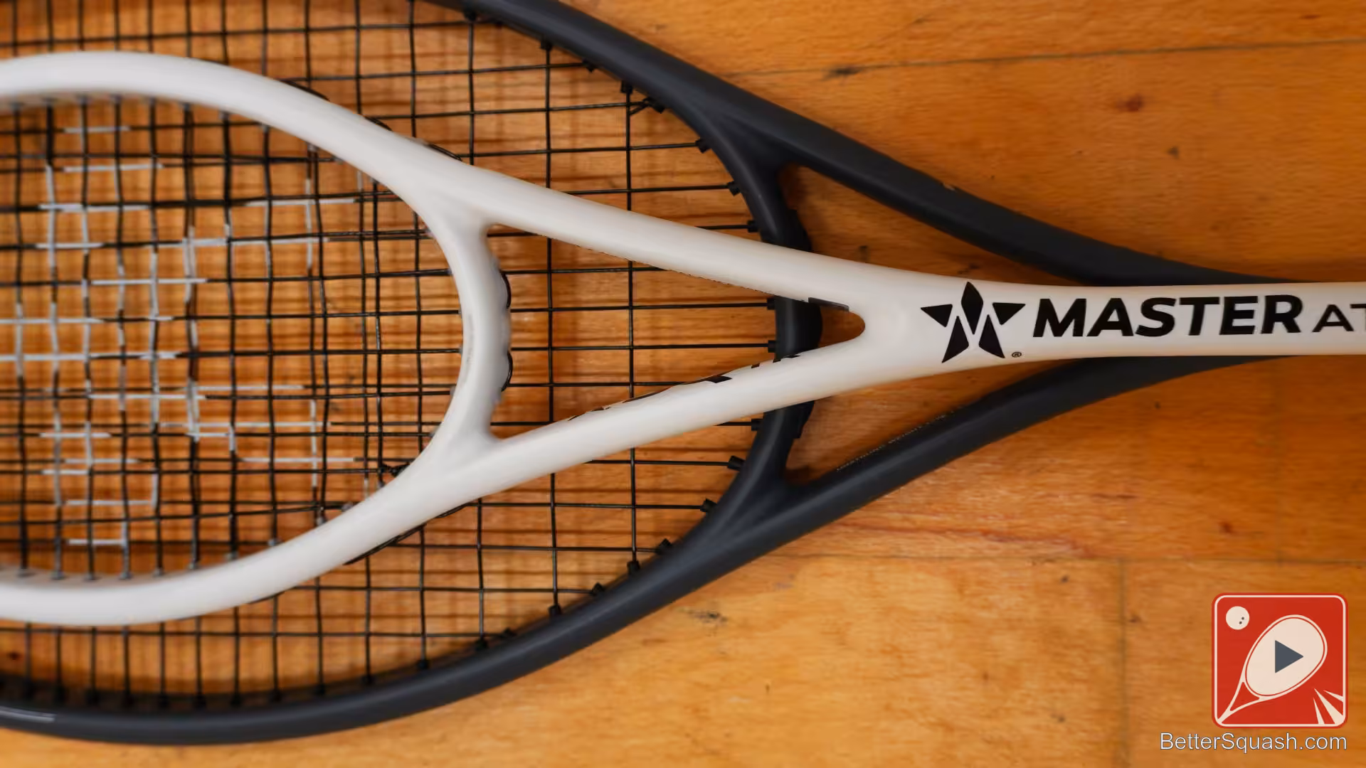 An overhead view of the Master Athletics Squash Training Racket compared to a normal sized squash racket