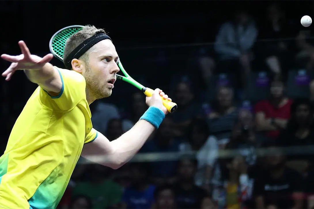 A squash player about to serve the ball