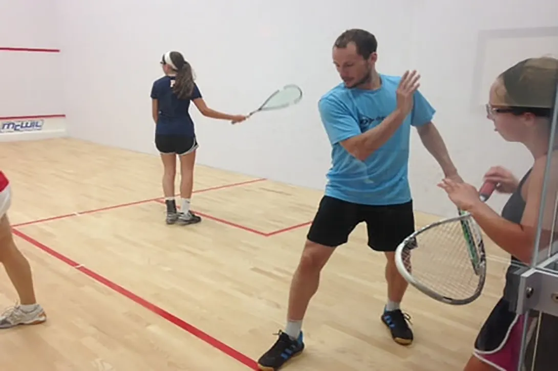 Gregory Gaultier showing some beginners how to swing a backhand squash shot